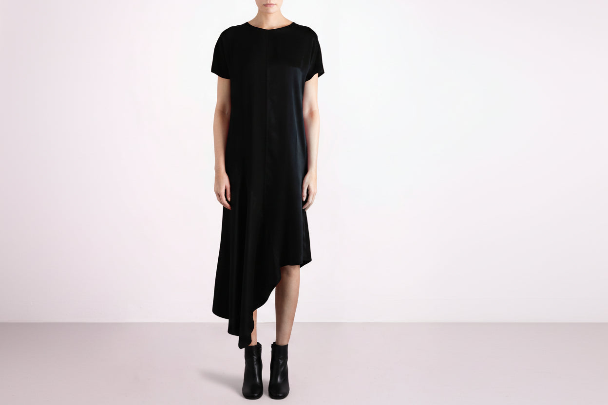 Black dress worn by a person on a white background