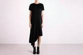 Black dress worn by a person on a white background